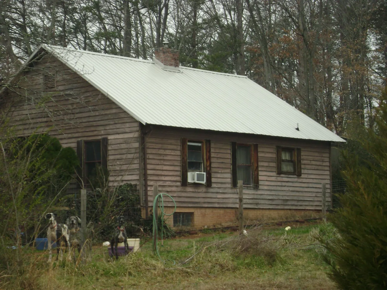 White metal roof on an old wood sided farmhouse, from a Metal Roof Installation job in Andalusia